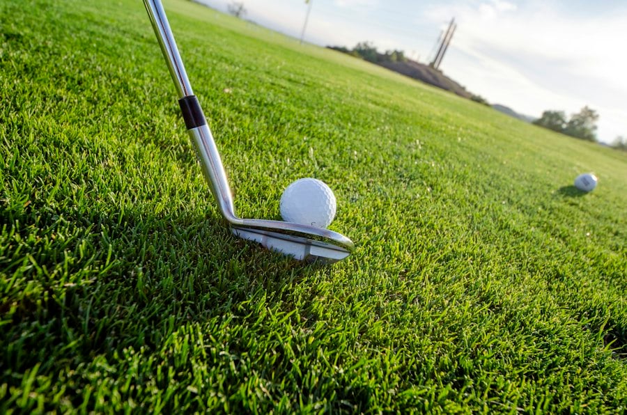 Iron address behind a golf ball on short grass