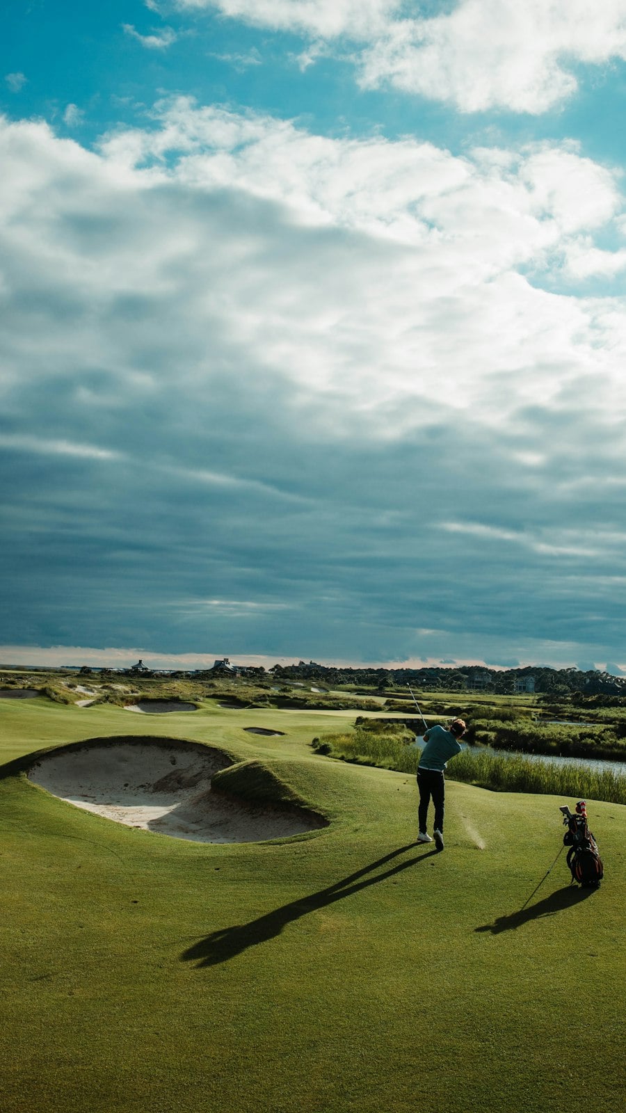 Golfer on a links fairway beside a bunker